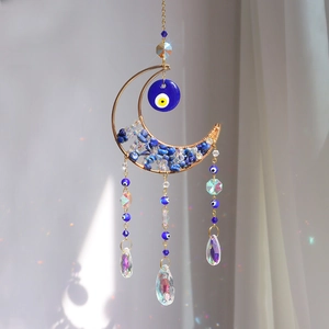 Detail of moon suncatcher with evil eye, blue stones and crystal prism droplets