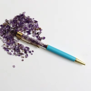 Blue ballpoint pen with transparent top filled with purple natural crystal crushed stones
