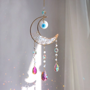 Macro detail of moon suncatcher with evil eye beads and rainbow crystal prisms
