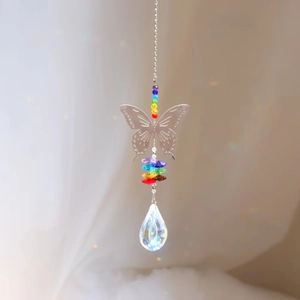 Macro detail of butterfly suncatcher with rainbow beads and faceted teardrop crystal