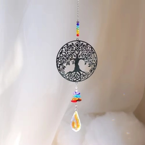 Detail of tree of life suncatcher with colorful chakra beads and crystal prism drop