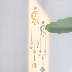 Macro detail of moon suncatcher with AB crystal ball and gold celestial pendants