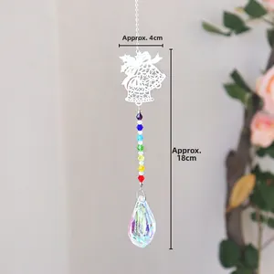 Macro detail of rainbow crystal suncatcher with star bell and faceted drop pendant