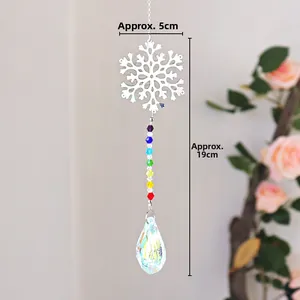 Detail of crystal suncatcher with silver snowflake and faceted water drop pendant