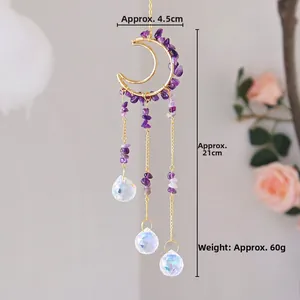 Detail of moon suncatcher with purple amethyst crystals and clear faceted prisms