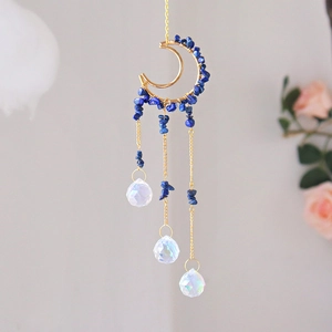 Detail of moon-shaped suncatcher with blue healing stones and clear crystal prisms