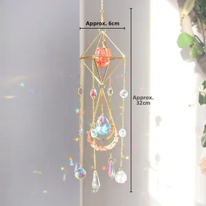 Detail of golden suncatcher with crystals casting rainbow prism light on a wall