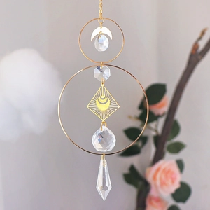 Detailed view of gold suncatcher with celestial moon charms and prismatic crystal spheres