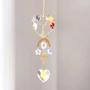 Macro shot of Tree of Life suncatcher with colorful crystals and golden celestial charms