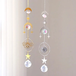Detail of celestial suncatchers with metal moon stars and faceted crystal prisms