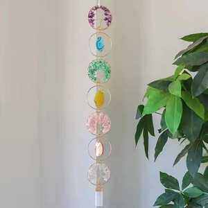 Detailed close-up of handmade 7 chakra tree of life wall hanging with natural crystals