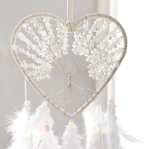 Detail of heart dream catcher with crystal tree of life and soft white feathers
