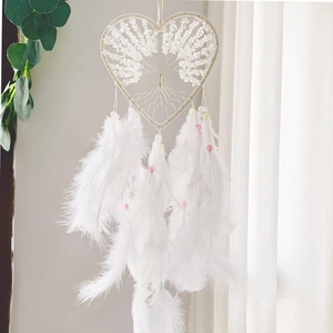 Macro shot of white heart dreamcatcher featuring tree of life and crystal bead detail