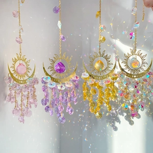 Set of 4 celestial crystal suncatchers with moon and sun motifs creating rainbow reflections