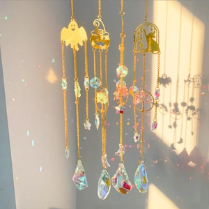 Detail of Halloween sun catcher with crystal prisms casting rainbow light reflections