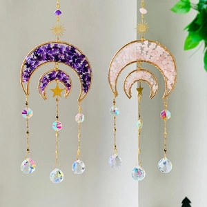 Detail of rose quartz moon suncatcher with gold wire weaving and crystal prisms