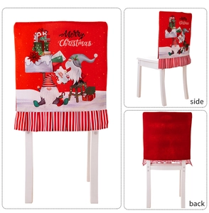 Detail view showing red gnome Christmas chair cover with striped pleated skirt and Merry Christmas print