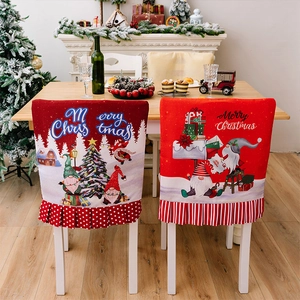 Detail of Christmas chair covers with gnome patterns and Merry Christmas text decor