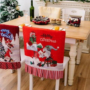 Close-up of red Christmas chair covers with Santa Claus and Merry Christmas prints