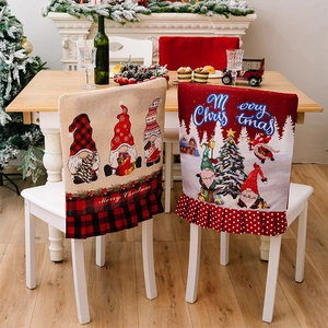 Detail of Christmas chair covers with gnome prints and ruffled hems for holiday dining