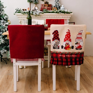 Detail of Christmas chair covers with gnome prints and red black plaid pleated edges