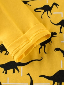 Kids long sleeve yellow dinosaur print t-shirt showing fabric texture and cuff detail