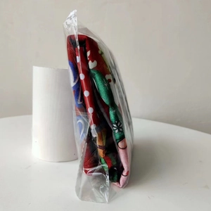 Detail view of the Christmas chair cover fabric thickness in transparent packaging