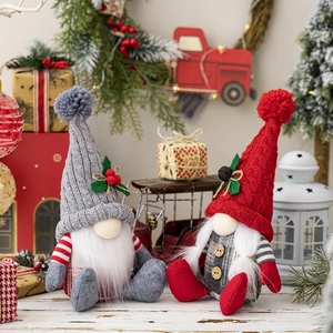 Detail of Christmas gnomes with knitted hats and berries in a festive home setting