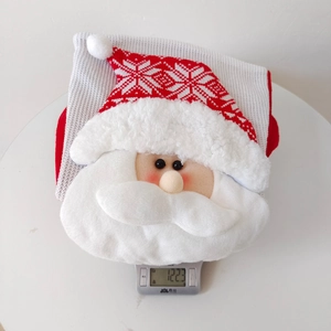 Detailed view of knitted Christmas stocking with 3D Santa motif on electronic scale