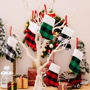 Plaid Christmas stocking ornaments with faux fur trim hanging on a white holiday tree