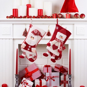 Premium Nordic Christmas stockings with 3D Santa and Snowman designs hung on a fireplace