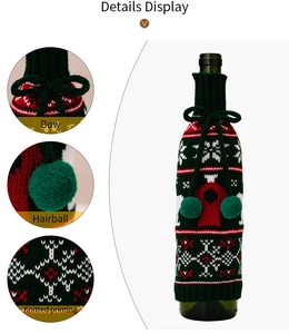 Detail view of knitted Christmas wine bottle cover with bowknot and pom pom accents