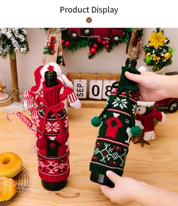 Close-up of festive knit wine bottle covers with snowflakes and cute pom-poms