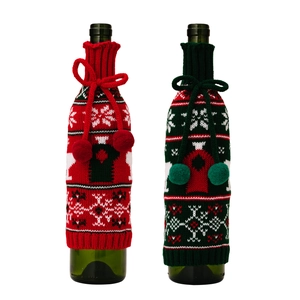 Christmas knitted wine bottle covers with snowflakes and decorative bows in red and green