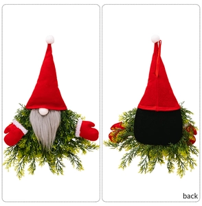 Front and back detail of a glowing Christmas gnome wreath with red felt hat and pine needles