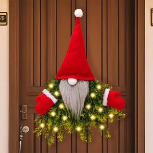 Illuminated Christmas gnome wreath with glowing LED lights on a rustic wooden door