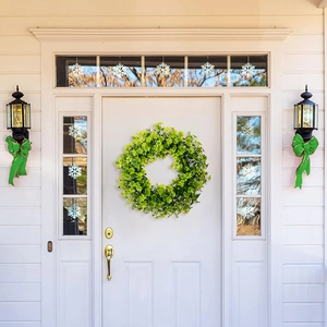 Detailed close-up of St. Patrick's Day clover wreath with dense green leaves on white door