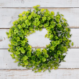 Detailed view of Saint Patrick's Day green clover wreath on white wooden floor