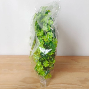 Saint Patrick's Day green clover wreath in transparent protective plastic packaging