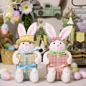 Detail of plush Easter bunny dolls with plaid gift boxes in a spring holiday setting