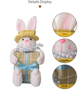 Detail display of white plush Easter bunny with yellow hat and gift box textures