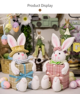 Detailed view of plush Easter bunny figurines on checkered gift boxes for decor