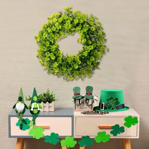 Lush green St. Patrick's Day wreath decoration with festive clovers and hat on a wall
