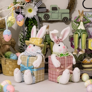 Easter plush bunny figurines in pink and yellow plaid gift boxes with floral decor