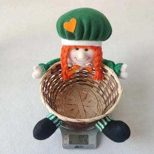 Detail of St. Patrick's Day doll on a woven candy basket with green hat and orange braids
