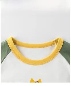 Detail of baby raglan shirt neckline with yellow ribbed edge and forest green sleeves