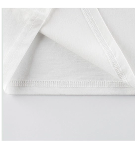 Close-up of white cotton girls T-shirt hem with professional double-needle stitching