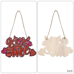 Front and back detail of a wooden heart pendant featuring Kiss Me text and jute rope