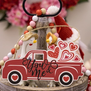 Detail of red wooden truck ornament with You and Me text and hearts for Valentine decoration