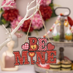 Detail of Be Mine wooden Valentine heart ornament hanging on white branch